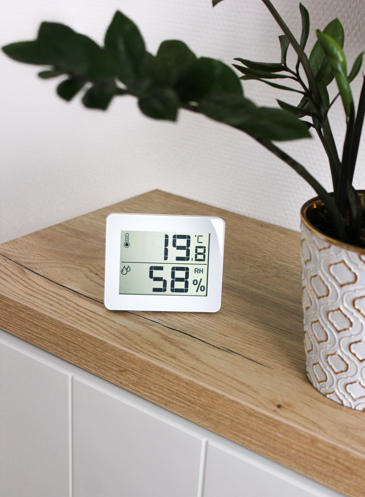 Thermo-hygrometer measuring the optimum temperature and humidity in a house for growing potatoes indoors